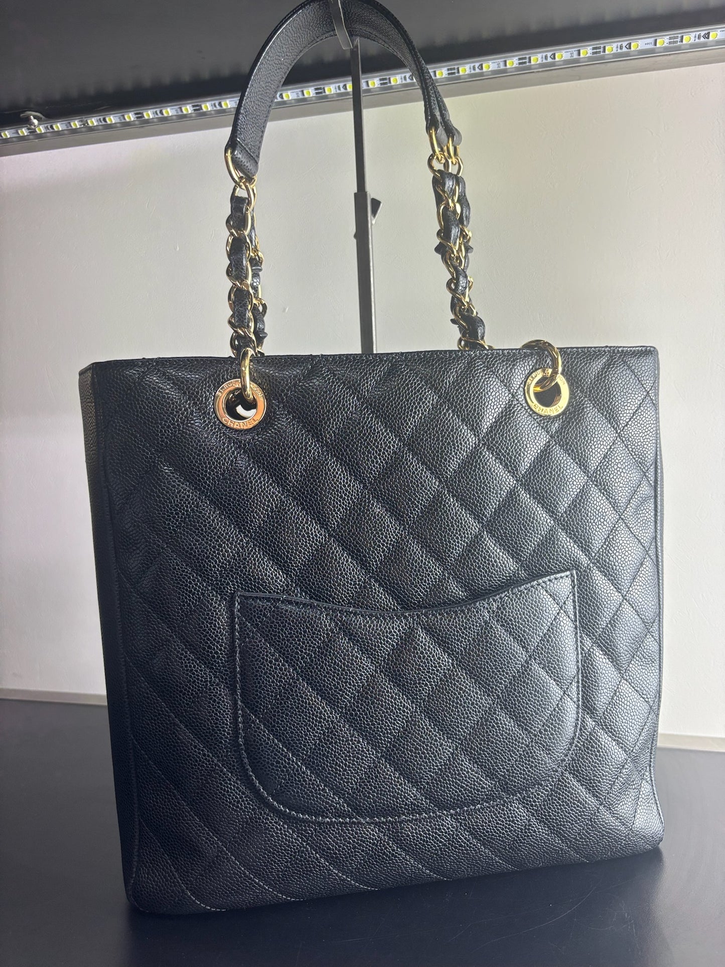 Chanel Petite Shopping Tote crafted in black caviar leather